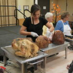 A woman carving a turkey